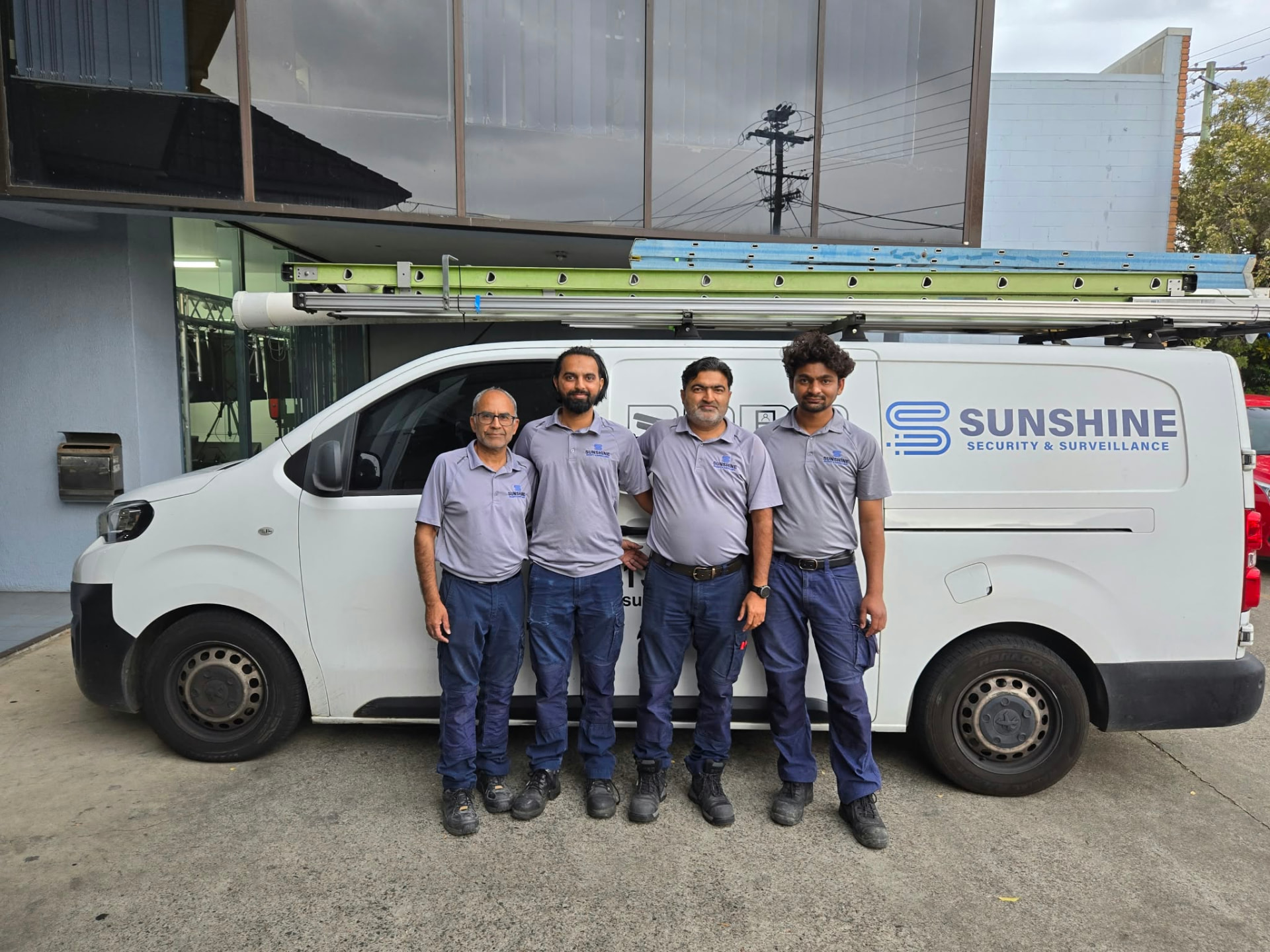 The Sunshine Security team standing in front of their branded work van